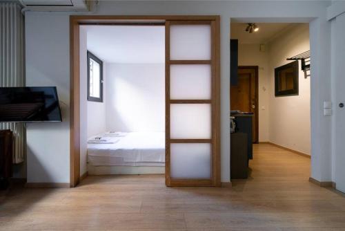 a room with a door leading to a bedroom with a bed at Plaka's quality studio in Athens