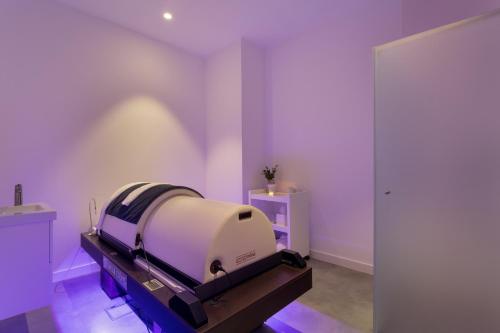 a room with a bed in a room with purple walls at Longevity Health & Wellness Hotel - Adults Only in Alvor