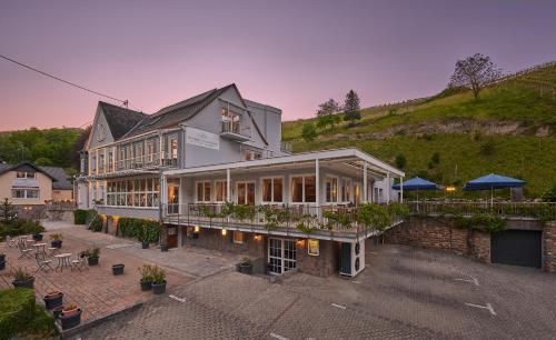 a large house with a lot of windows at Hotel Weinberg-Schlößchen in Oberheimbach