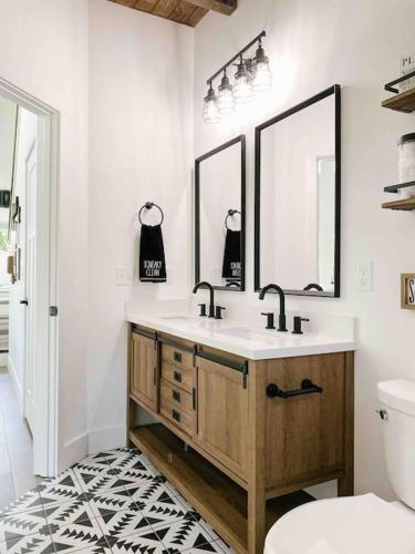 a bathroom with a sink and two mirrors at Cozy Smoky Mountain Tiny House in Pigeon Forge