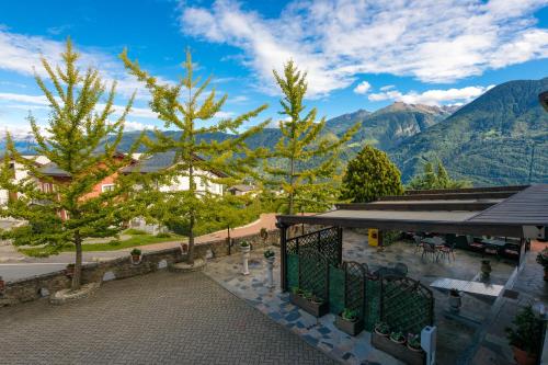 a view of a resort with mountains in the background at Hotel Ristorante Miravalle in Teglio