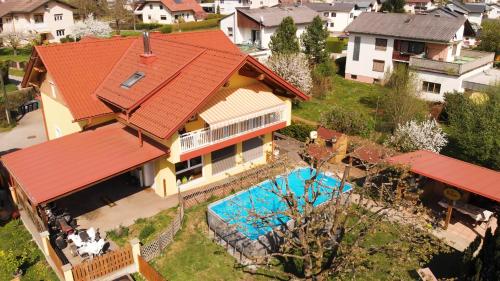 an aerial view of a house with a swimming pool at Home Sweet Home in Reichersdorf