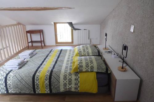 a bedroom with a bed and a desk with a bed sidx sidx sidx at Maisonnette climatisée avec parking privé in Montfort