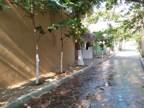 a street with trees on the side of a building at Casa Mazunte Tierra Viva in Mazunte