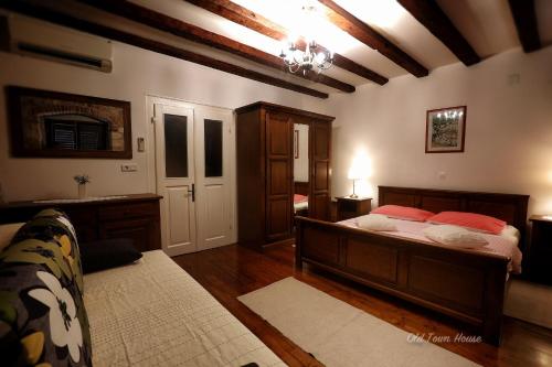 een slaapkamer met een bed in een kamer met een plafond bij Old town house in Pag