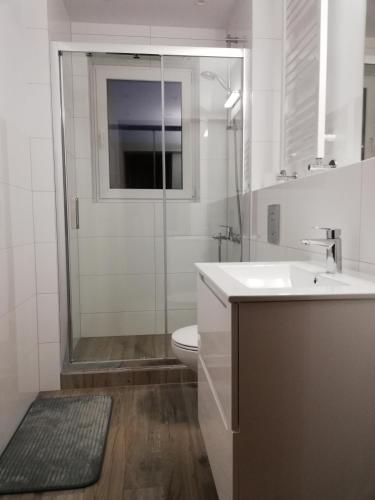 a bathroom with a toilet and a sink and a shower at Pokoje Gościnne Alpinka in Ustka