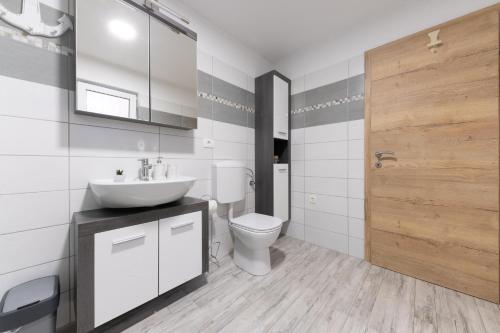 a bathroom with a sink and a toilet at Apartments Gea in Lucija