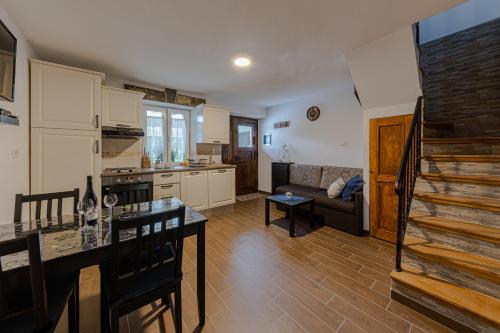 a kitchen and living room with a table and a couch at Apartments Gea in Lucija