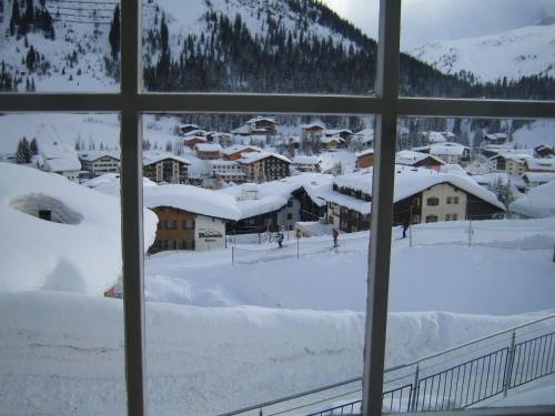 a view from a window of a town covered in snow at Haus Dr. Küng in Lech am Arlberg
