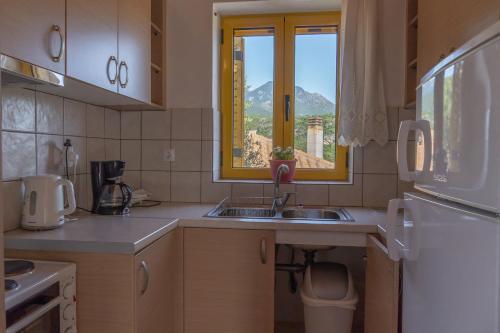 a kitchen with a sink and a window at Trisilio in Kardamili
