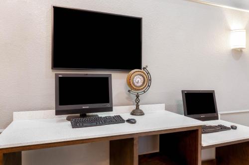 a desk with a computer monitor and a laptop on it at La Quinta by Wyndham Kerrville in Kerrville