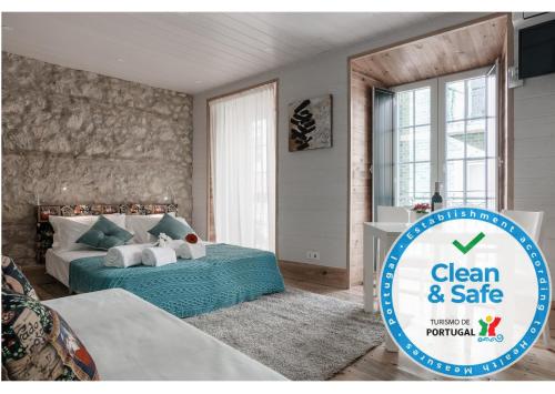 a bedroom with a bed and a sign that says clean and safe at My Bairro Alto Suites in Lisbon