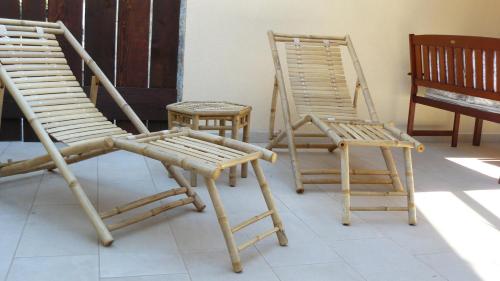 a group of chairs and a pair of tables at Eco Apartments Kate in Suđurađ
