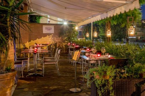 a restaurant with tables and chairs under a tent at Best Western Blu Hotel Roma in Rome
