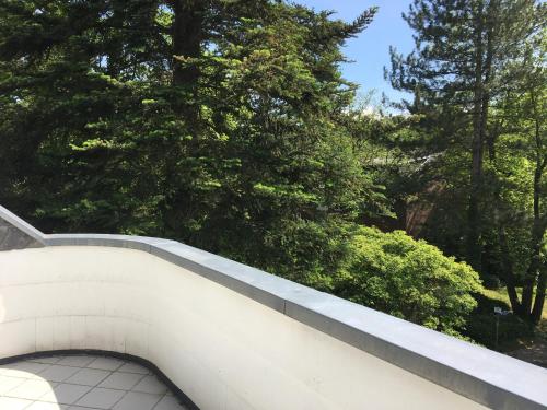a white wall with trees in the background at Villa Hortensie in Aachen