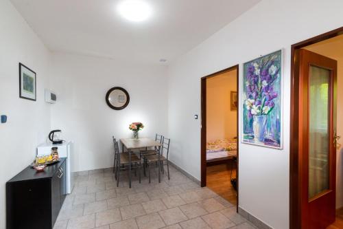 a hallway with a table and a dining room at Penzion Kozí farma Nový Dvůr in Česká Lípa