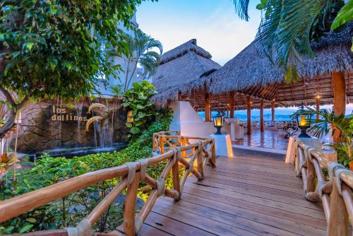 a wooden walkway to a resort on the beach at Las Hadas by Brisas in Manzanillo