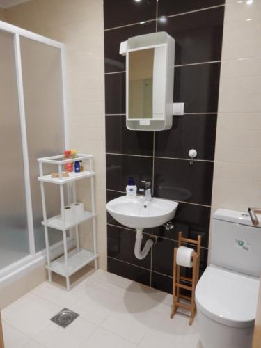 a bathroom with a sink and a toilet and a mirror at Zlatiborska ćurka in Zlatibor