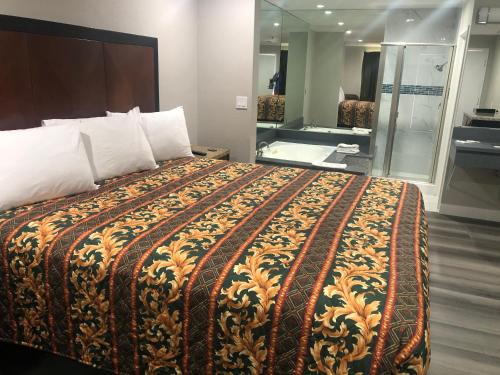a hotel room with a large bed in a room at Economy Inn - Ontario Airport in Ontario