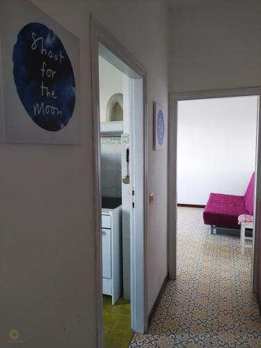 a hallway with a door with a sign that reads wait for the wrong at Ghiaie sea view in Portoferraio