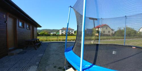 a hammock in a yard with a house at Apartamenty przy Jeziorze Żywieckim z widokiem na Skrzyczne in Żywiec