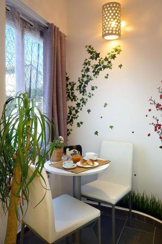 a table and chairs with a plate of food on it at B&B Sorrento Central in Sorrento
