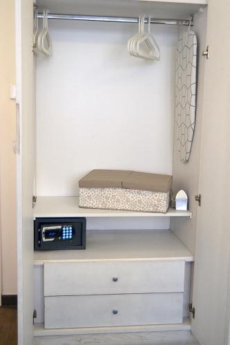 a closet with a box sitting on a shelf at B&B Sorrento Central in Sorrento