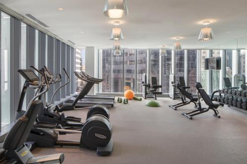 a gym with treadmills and exercise equipment in a building at Lotte Hotel Seattle in Seattle