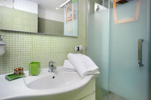 a bathroom with a sink and a glass shower at B&B Sorrento Central in Sorrento