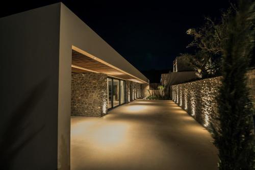 a building with lights on the side of it at night at Nuez Villas in Mochlos