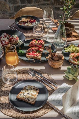 a table with plates of food on top of it at Nuez Villas in Mochlos
