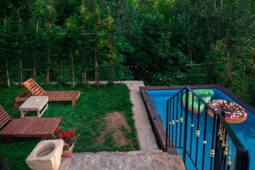 a backyard with a pool and a bench and a table at Austria Luxury Apartments, Faraya Hotel in Fārayyā