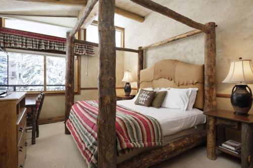 a bedroom with a four poster bed and a desk at Shadowbrook 304 in Snowmass Village