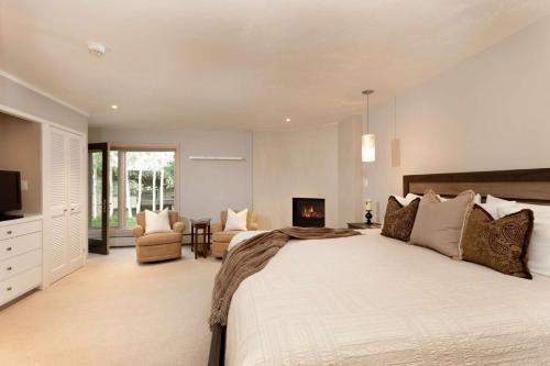 a large bedroom with a large bed and a fireplace at Shadowbrook 104 in Snowmass Village