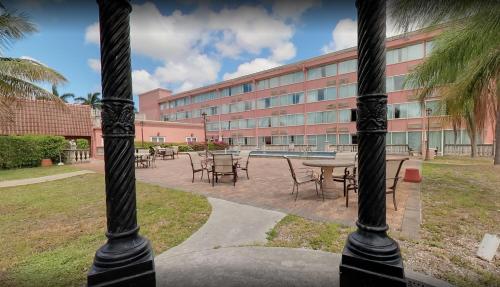 a building with tables and chairs in a courtyard at Miami Gardens Inn & Suites in Miami