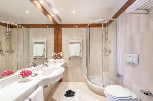 a bathroom with a sink and a shower and a toilet at The Regency Sure Hotel Collection by Best Western in Lissone