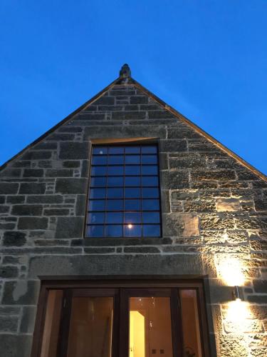 a window on the side of a brick building at Kilmorie House in Elgin