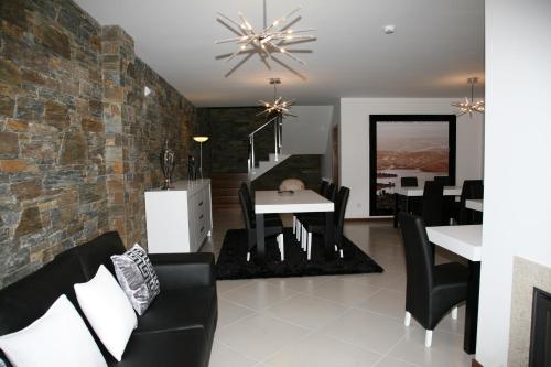 a dining room and living room with a table and chairs at Casa de Vale Benfeito - Turismo Rural in Macedo de Cavaleiros