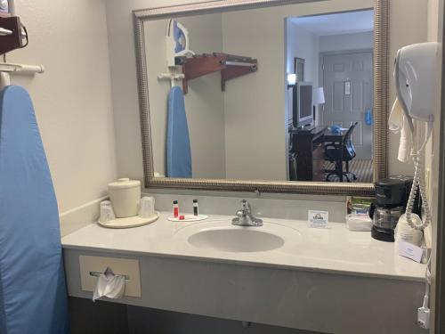 a bathroom with a sink and a mirror at Days Inn by Wyndham Ocean Springs in Ocean Springs