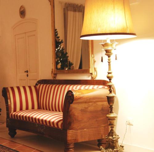 a lamp sitting next to a couch in a room at Casa d'Autore in Ostuni
