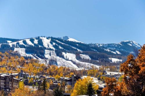 a town in the mountains with autumn trees at Woodbridge 21C in Snowmass Village