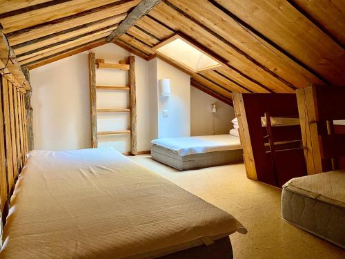 a bedroom with two bunk beds and a ladder at Lapland Tunturimaja Ski in, sauna, in Pyhä center - Lapland Villas in Pyhätunturi