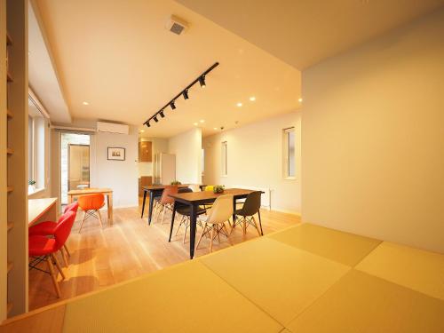 a dining room with a table and chairs at Family Tree Guest House in Sapporo