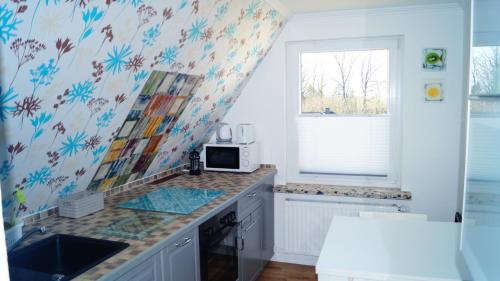 a kitchen with a sink and a microwave at Ferienwohnung Familie von Seggern in Bispingen