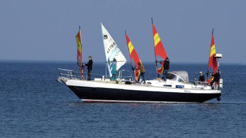 a group of people on a sail boat in the water at Strandhaus Brunhild in Timmendorfer Strand