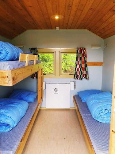 a room with two bunk beds and a window at City Camping Hjørring in Hjørring