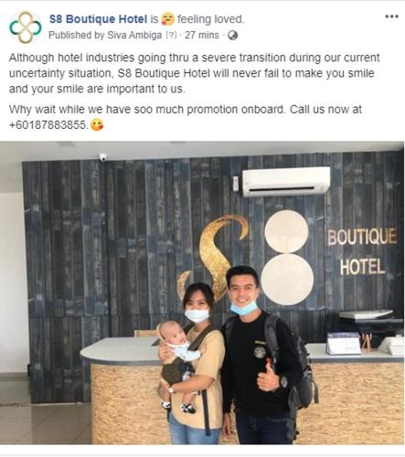 a man and a woman with a baby wearing masks at S8 Boutique Hotel near KLIA 1 & KLIA 2 in Sepang