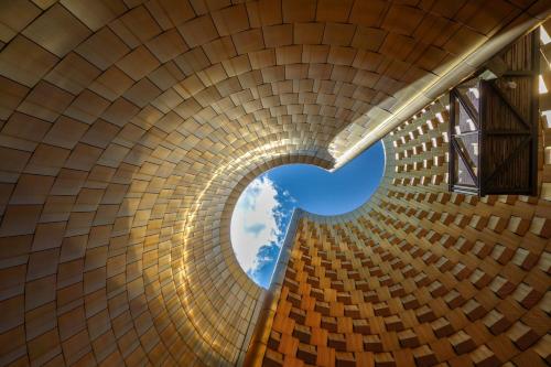 a brick tunnel with a blue sky in the center at Kyriad Clermont-Ferrand-Sud - La Pardieu in Clermont-Ferrand