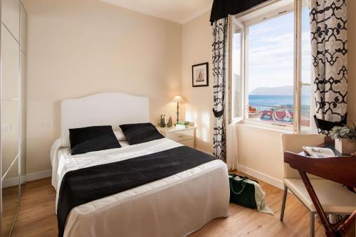 a bedroom with a bed and a large window at Hotel Lido in Alassio