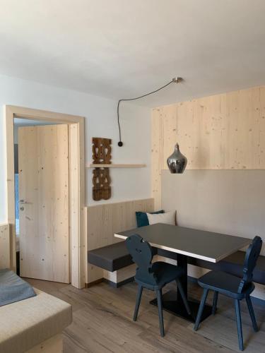 a dining room with a table and two chairs at Castell Matscher in Bressanone
